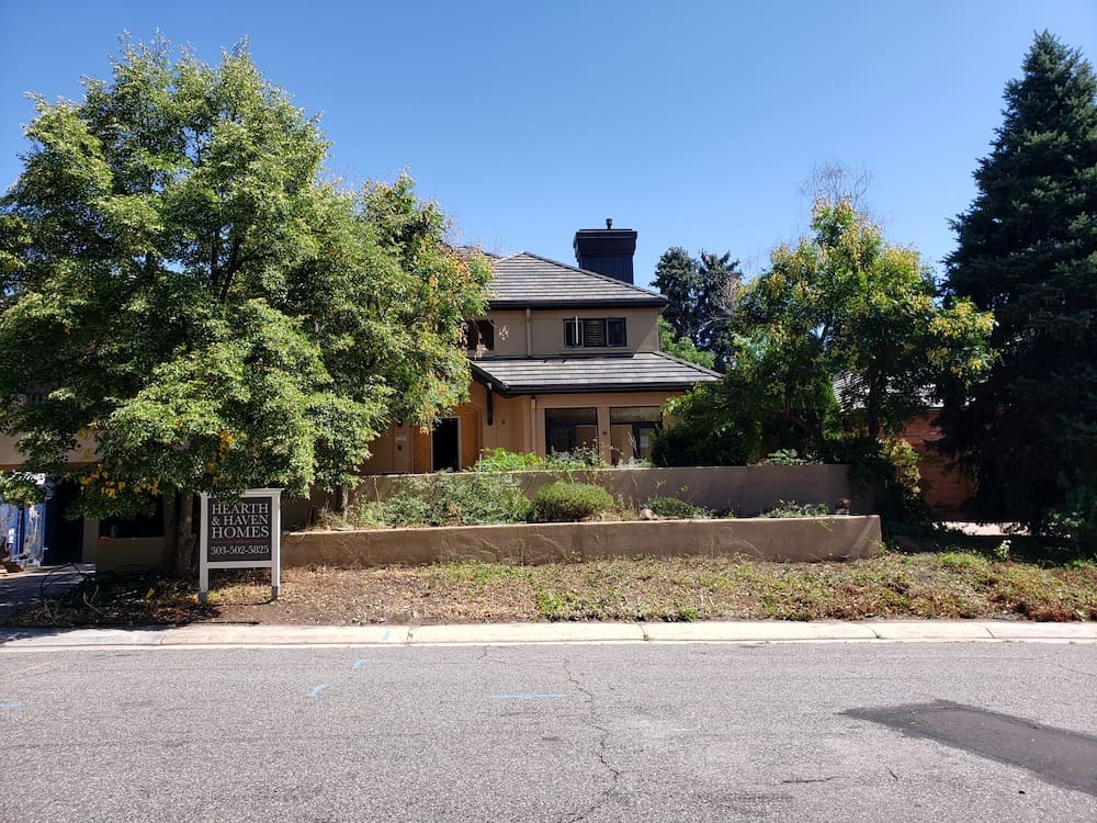 SuperTrees Colorado Landscape job before photo showing terraces and overgrown grasses.
