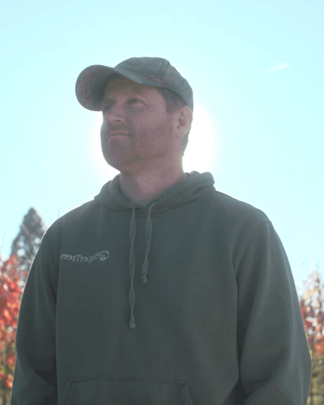 Brant Walker, SuperTrees owner and CEO, in green hoodie and baseball hat.