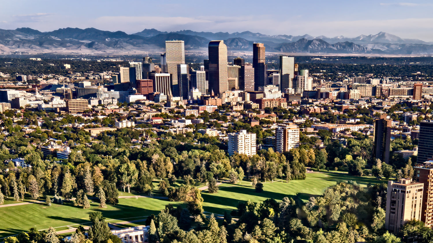 Denver, Colorado skyline with Rocky Mountains in the background.